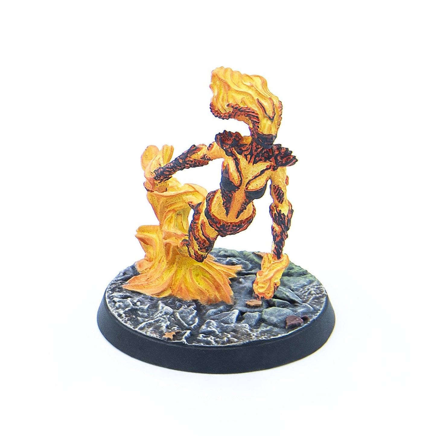 A miniature figure of a vibrant orange and yellow fire elemental with dark patterns, posed dynamically on a rocky base