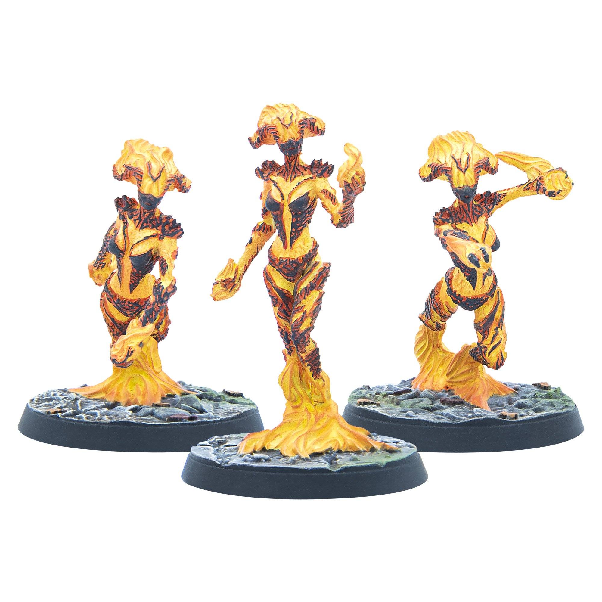 Three yellow, orange, and black molten humanoid miniatures in dynamic poses on round bases