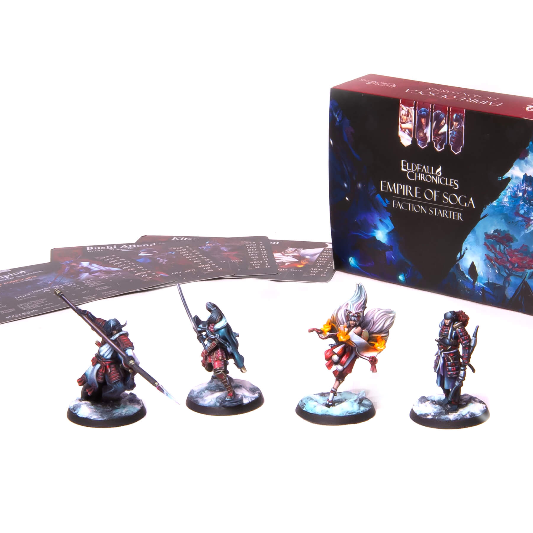 Four painted warrior miniatures, a game box for Eldfall Chronicles: Empire of Soga, and game cards on white