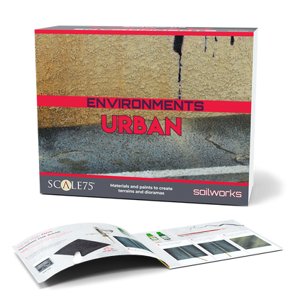 The Scale 75 Soilworks Scenery Environments Urban Set kit box features a textured urban scene with cracked asphalt and a weathered wall, alongside an open guide