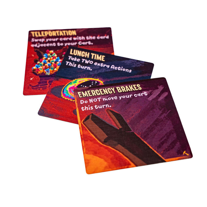 Three vibrant game cards fanned out, showing TELEPORTATION, LUNCH TIME, and EMERGENCY BRAKES