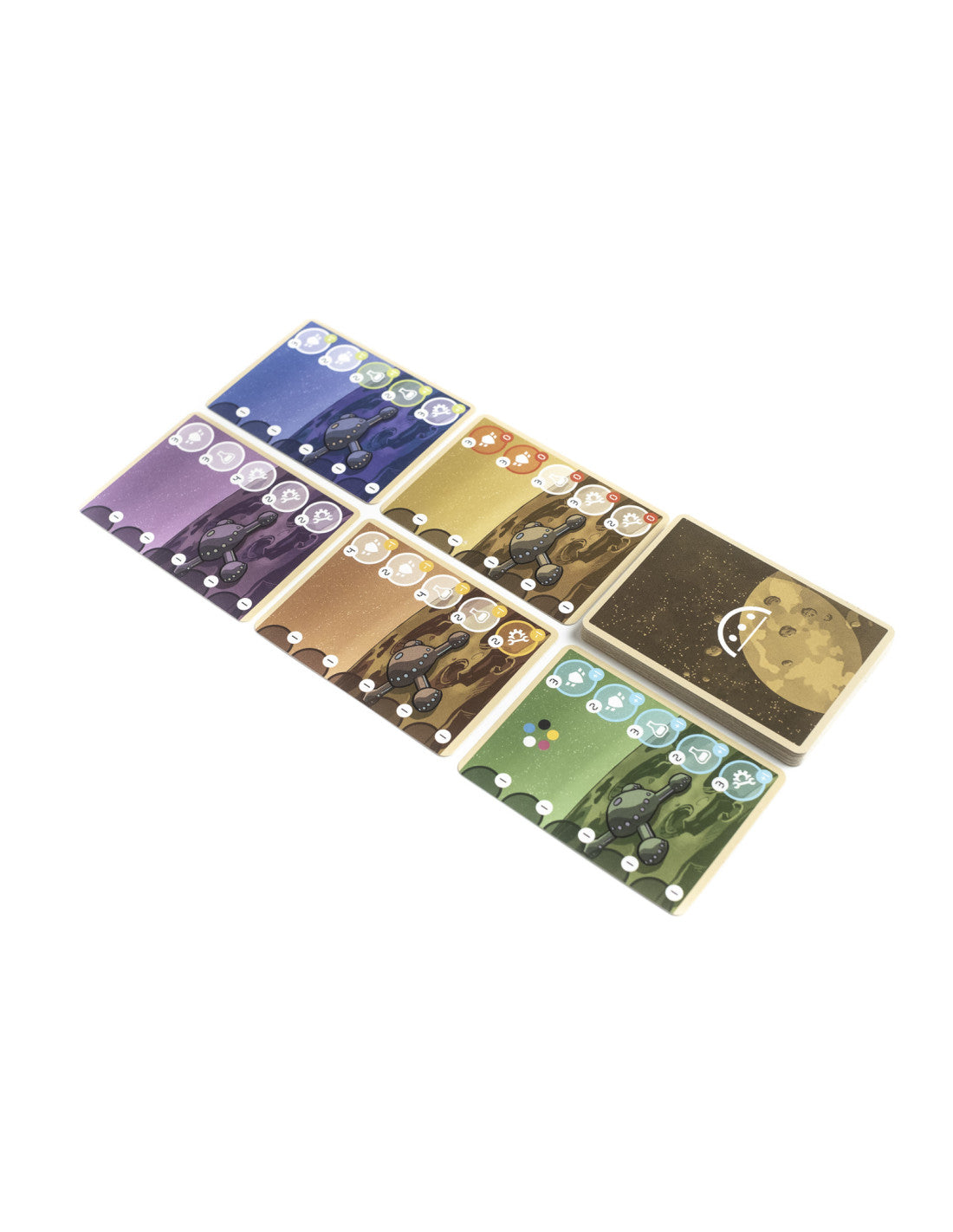 Colorful board game cards show planet landscapes with vehicles and resource icons. A stack of cards with a moon back is next to them.