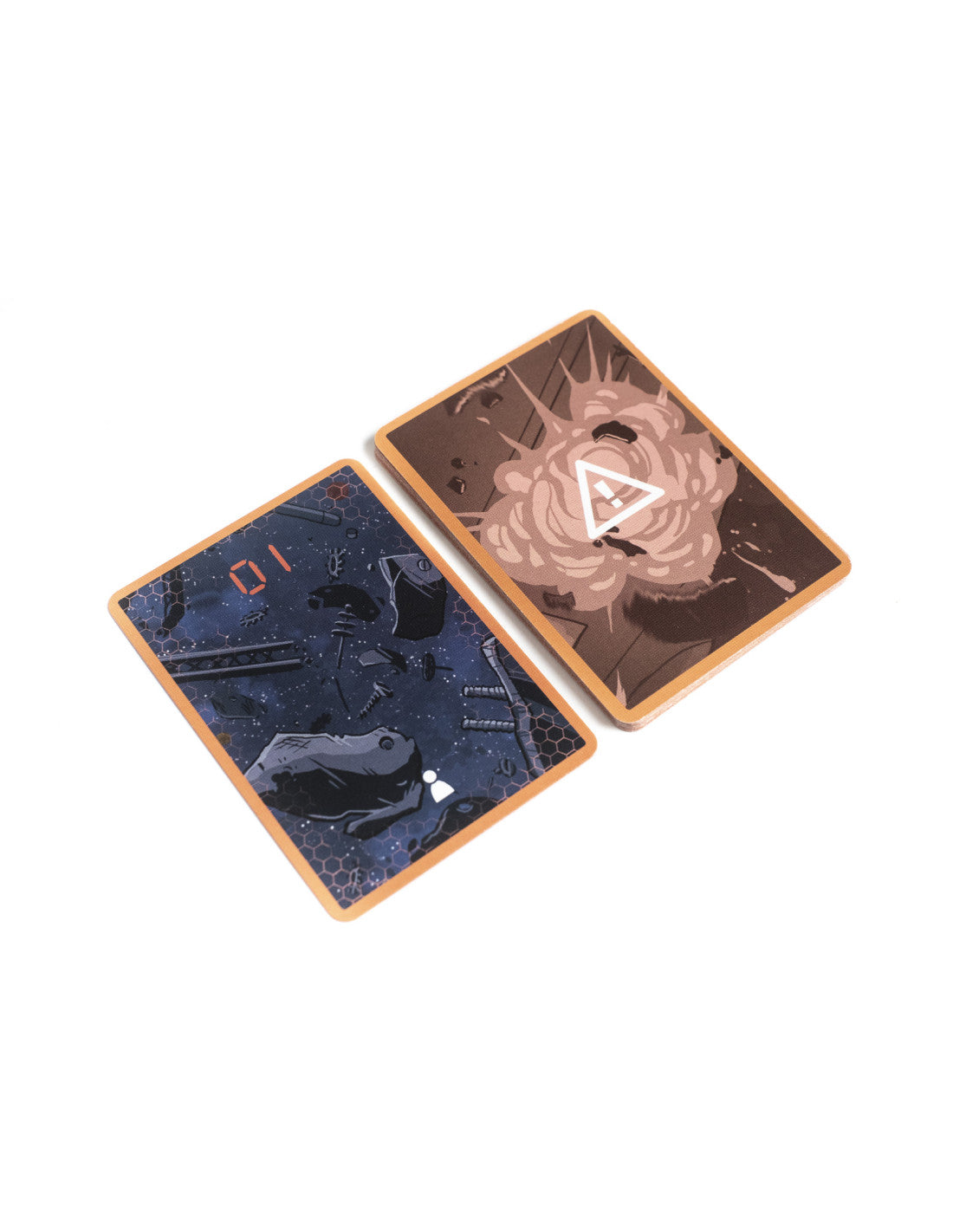 Two angled game cards on white. Left shows space debris with '01'; right depicts an explosion with a warning symbol.