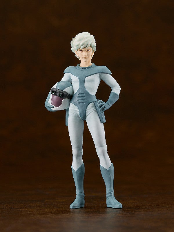 A male character figurine with white hair in a light blue and white pilot suit, holding a helmet