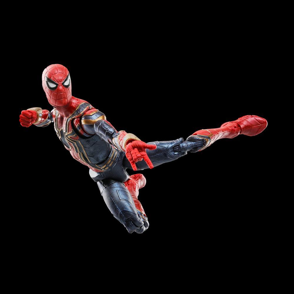 An action figure of Spider-Man in a red and blue suit with gold accents is in a dynamic pose against a black background