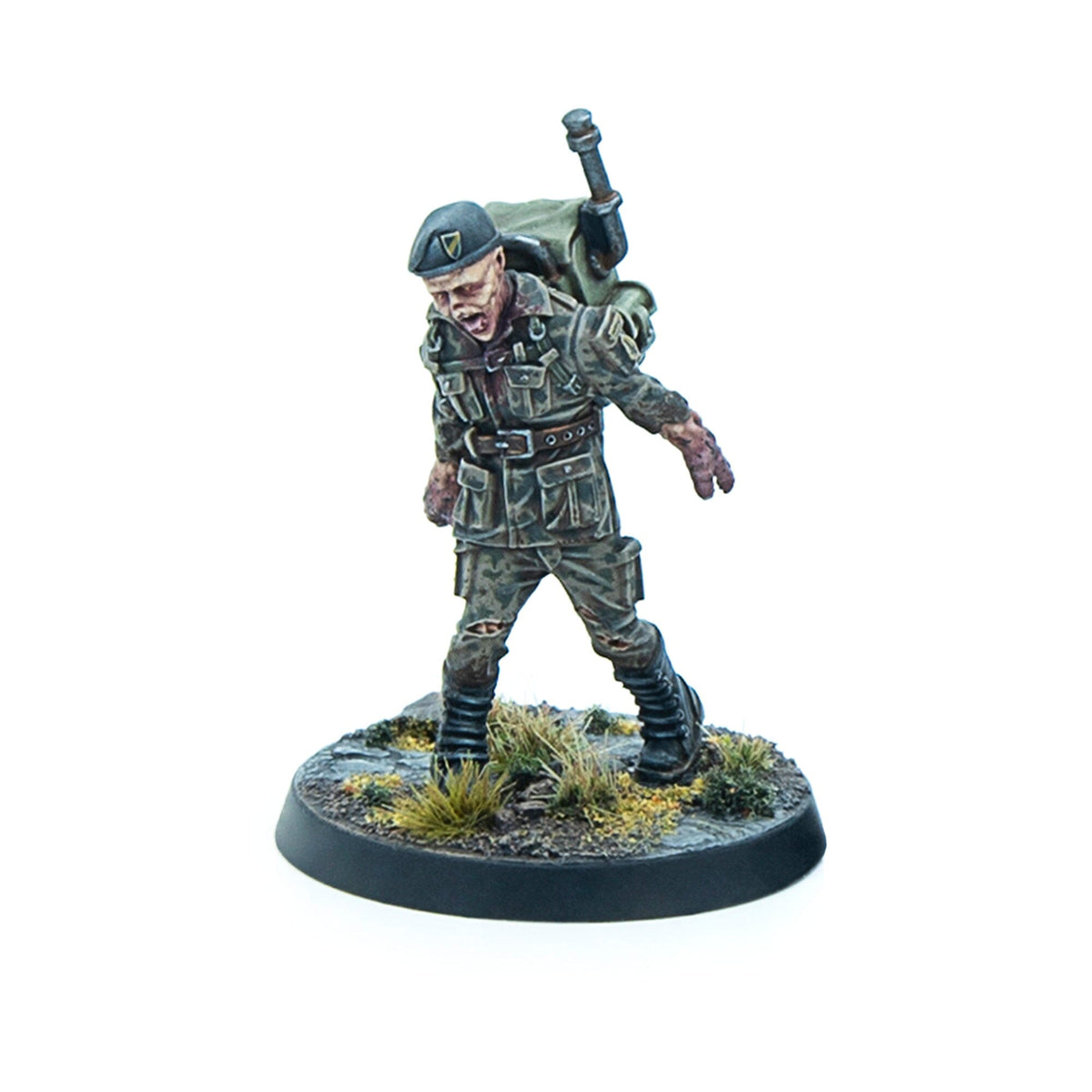 Miniature of a zombie soldier wearing a green beret and tattered camo, with an open mouth, shambling forward on a terrain base