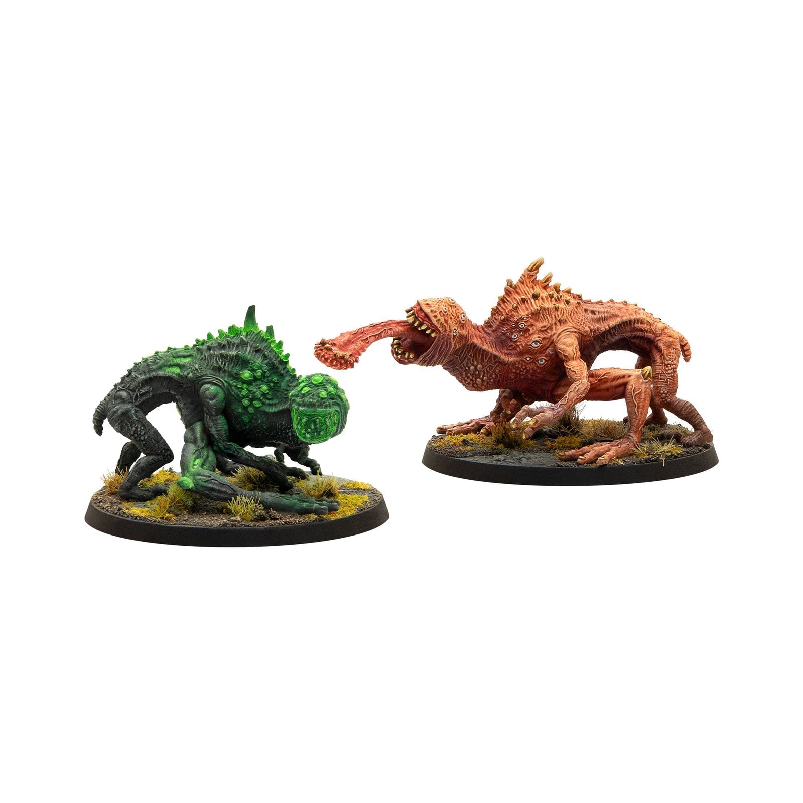 Two painted miniature creatures: a spiked green monster and an orange monster lunging with a long tongue