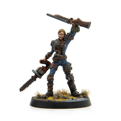Painted miniature of a woman in a blue uniform, wielding a chainsaw and raising a rifle.