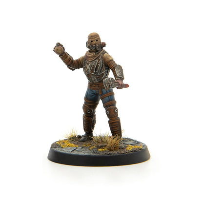Masked post-apocalyptic miniature figure holding a wrench and a crude grenade on a scenic base