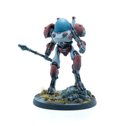 A grey and red sci-fi robot miniature with a blue domed helmet, standing on a rocky base holding a spear.