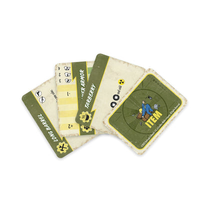 Fanned-out Fallout board game cards, including an "ITEM" card with Vault Boy lying on a crate, and "POWER ARMOR"