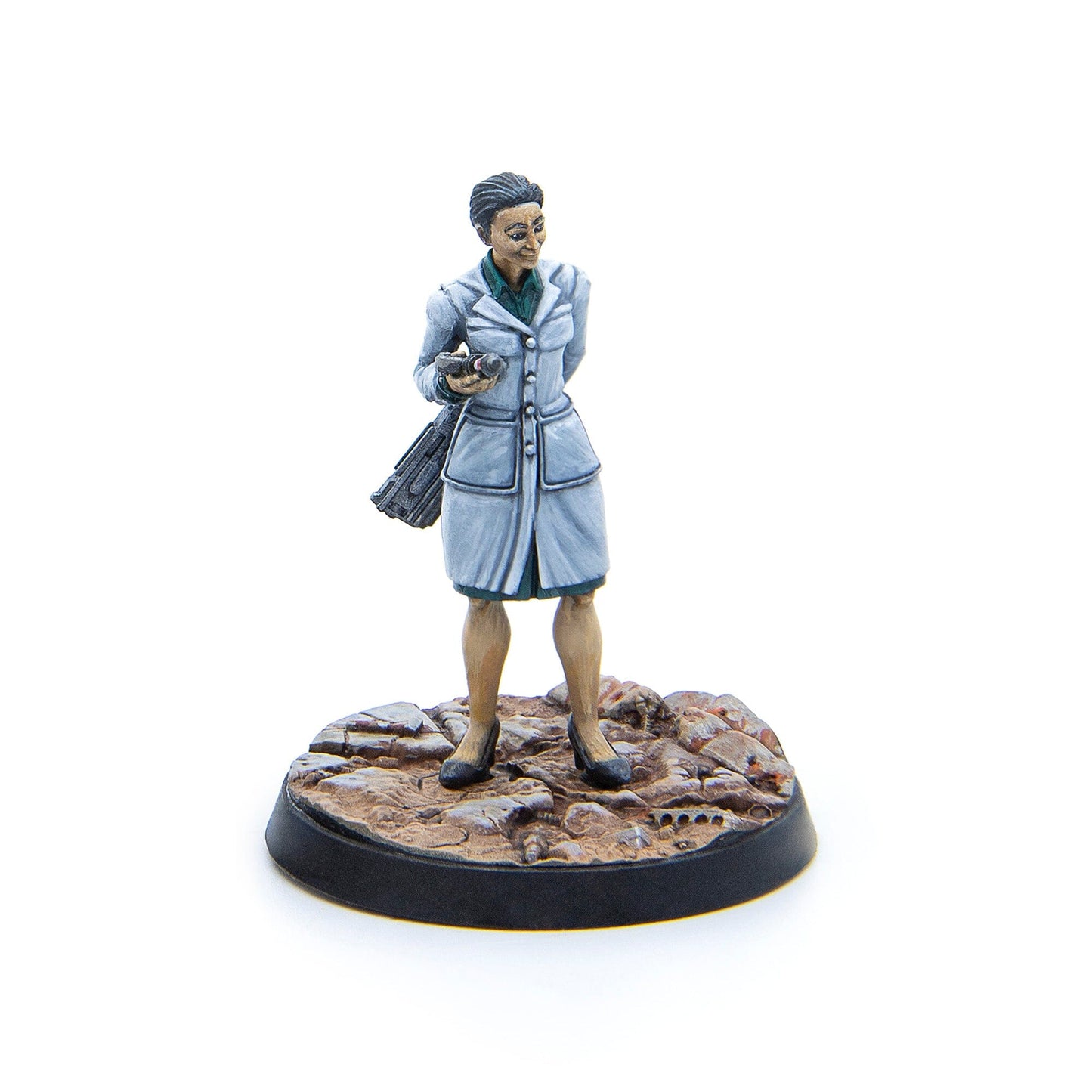 Hand-painted miniature of a woman in a light coat, holding a camera on a textured base