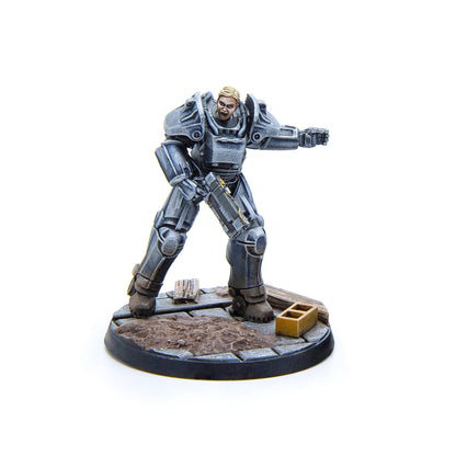 Fallout power armor miniature of a blonde woman, yelling, holding a rifle, and gesturing forward
