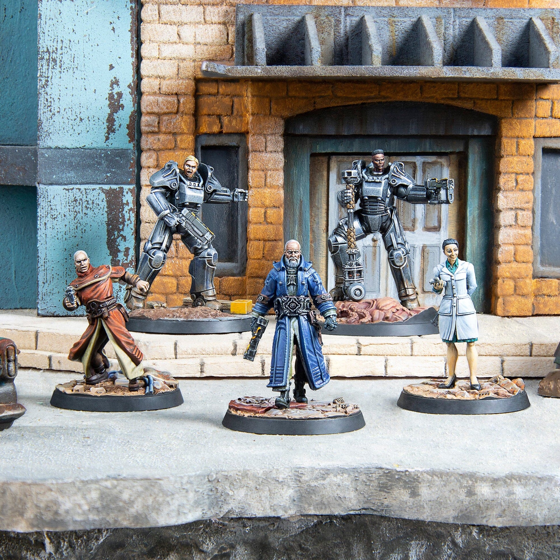 Five painted miniatures including two power-armored, two robed men, and a scientist, posed on a street