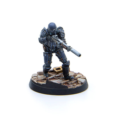 A painted miniature figure from Fallout Wasteland Warfare Brotherhood of Steel Combat Patrol featuring an armored soldier holding a rifle standing on a textured base