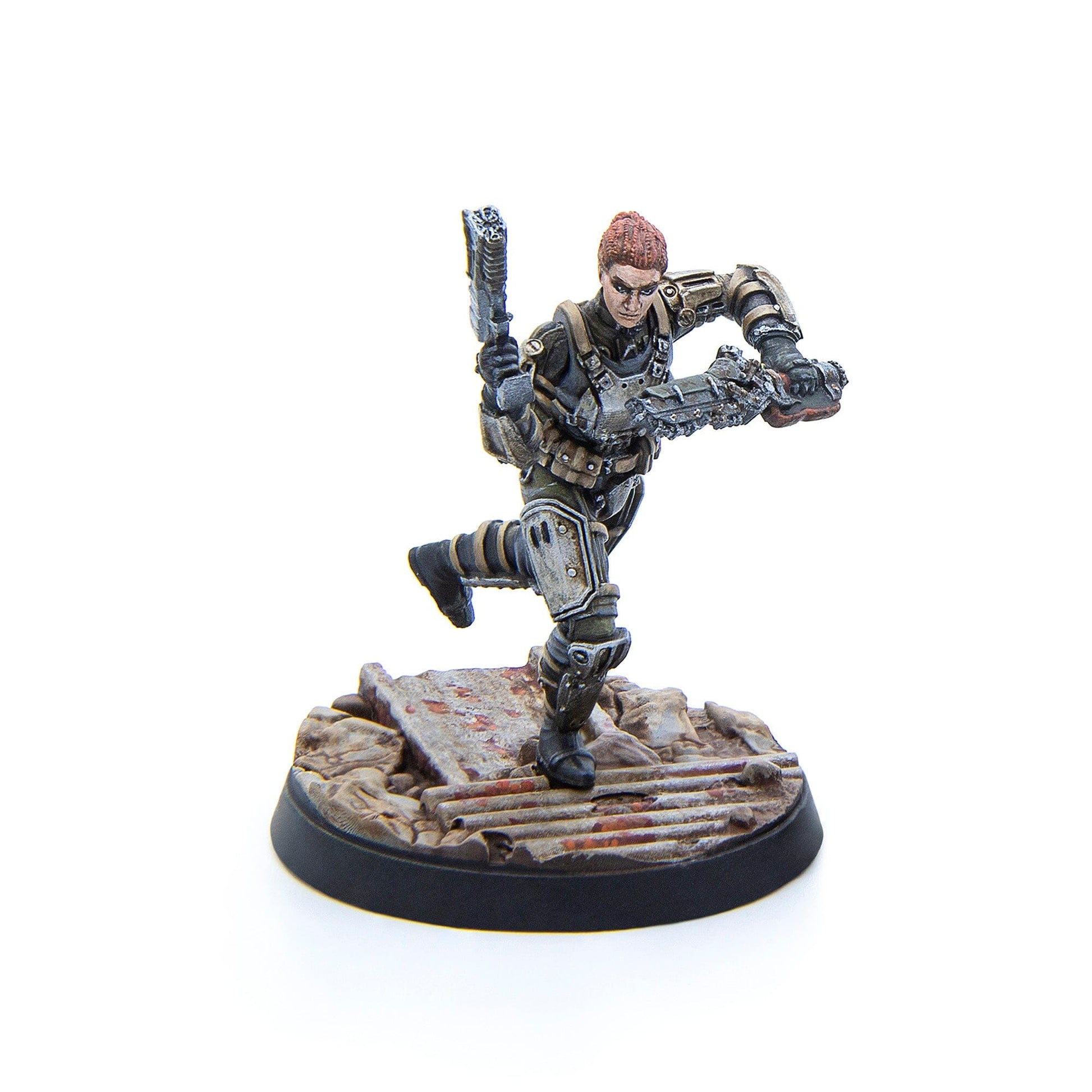 A miniature figure of a female character with red hair in armored tactical gear lunging while holding two weapons on a rubble base