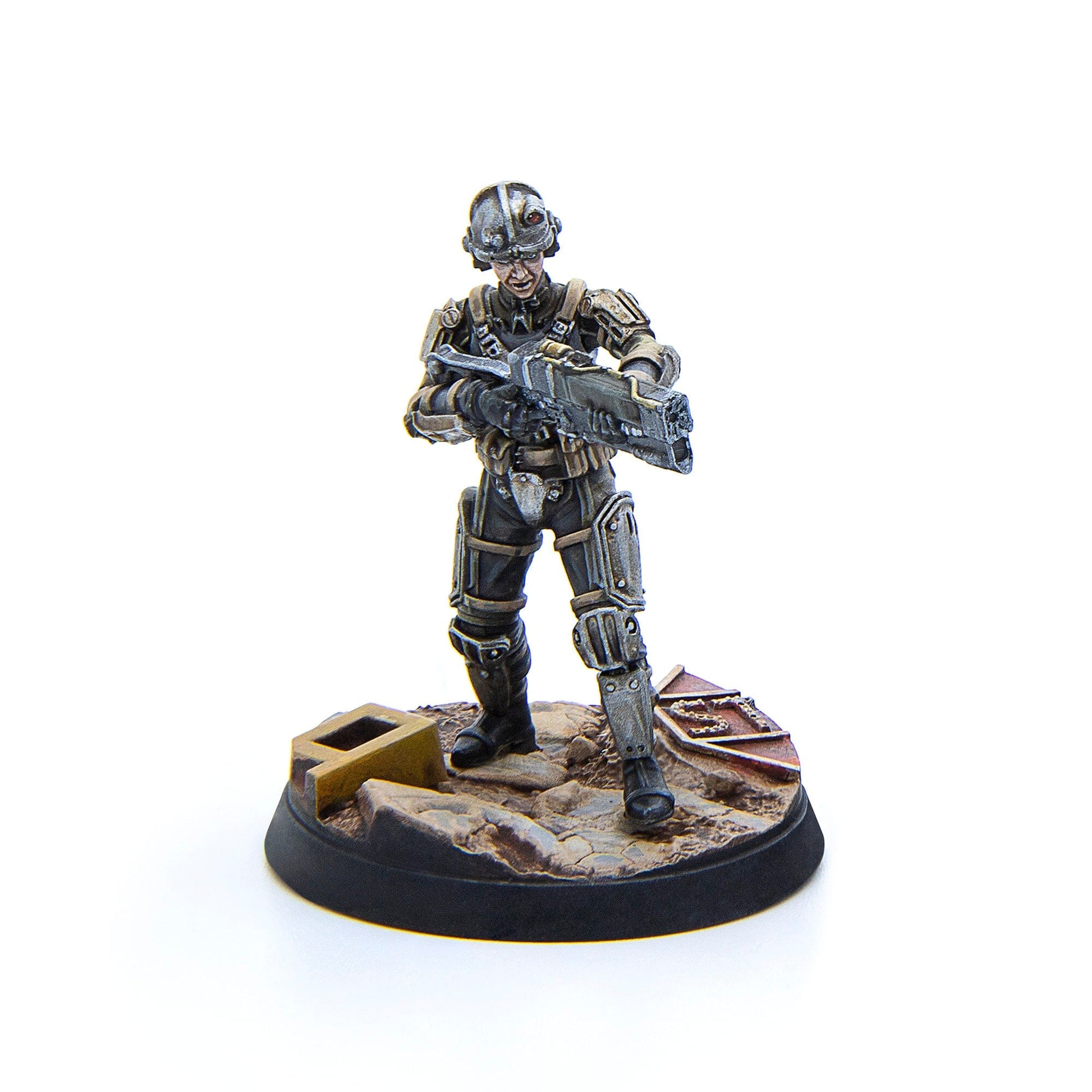 A detailed miniature figurine of a sci-fi soldier in full armor with a large rifle stands on a rocky base