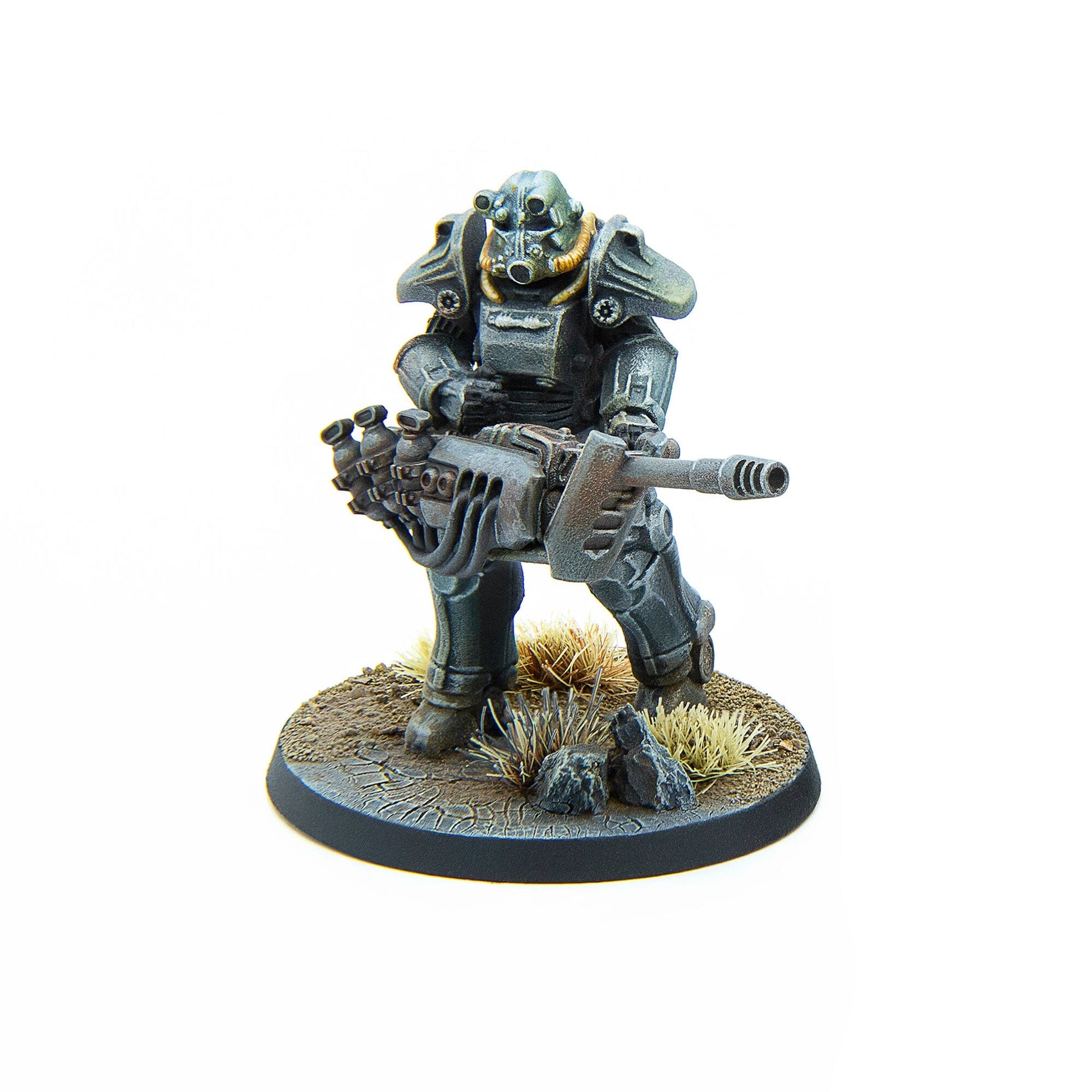 A painted Fallout Wasteland Warfare Brotherhood of Steel T-45 power armor miniature holding a heavy weapon on a terrain base