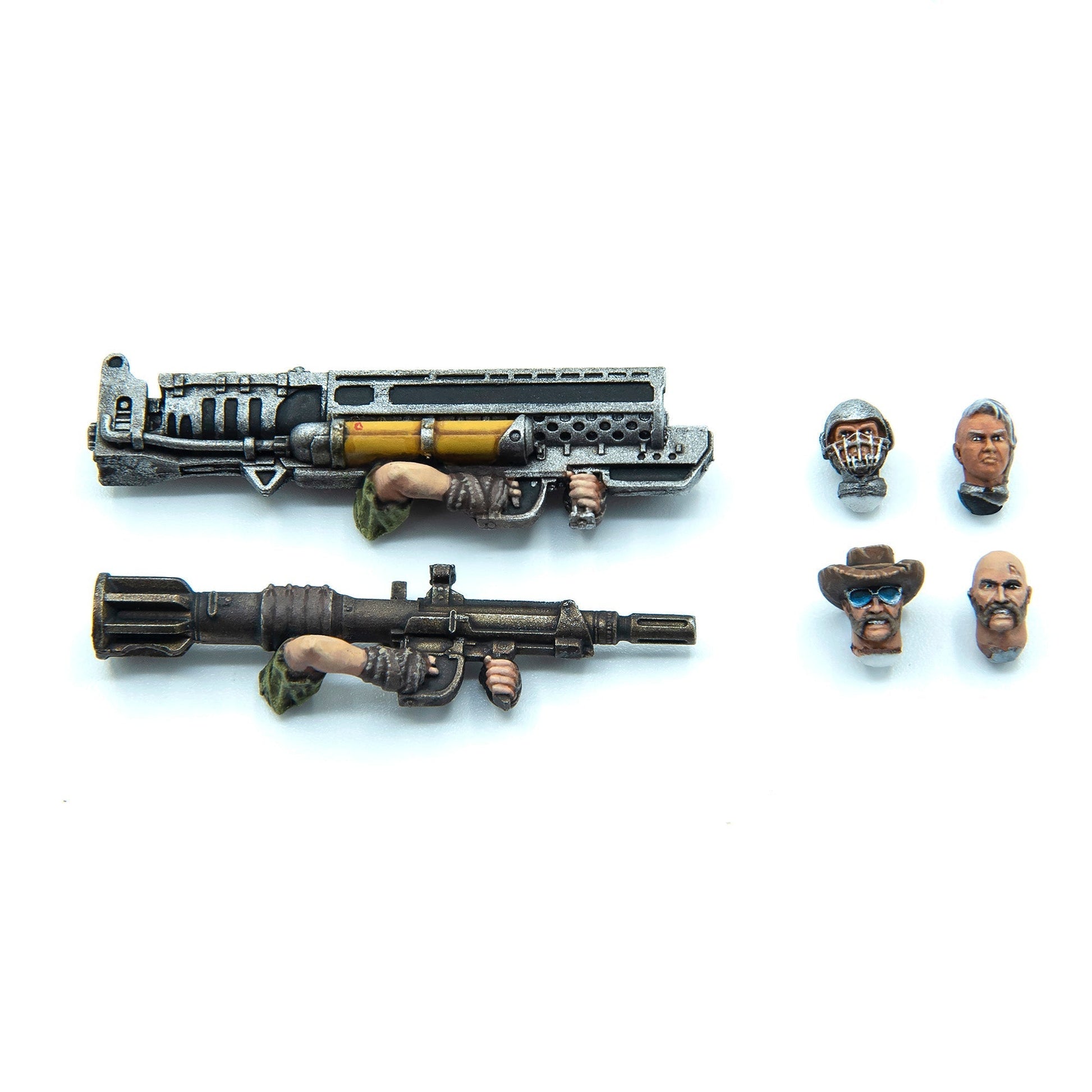 Miniature action figure parts: Two futuristic weapons held by hands, plus four distinct character heads like masked, cowboy, and bald