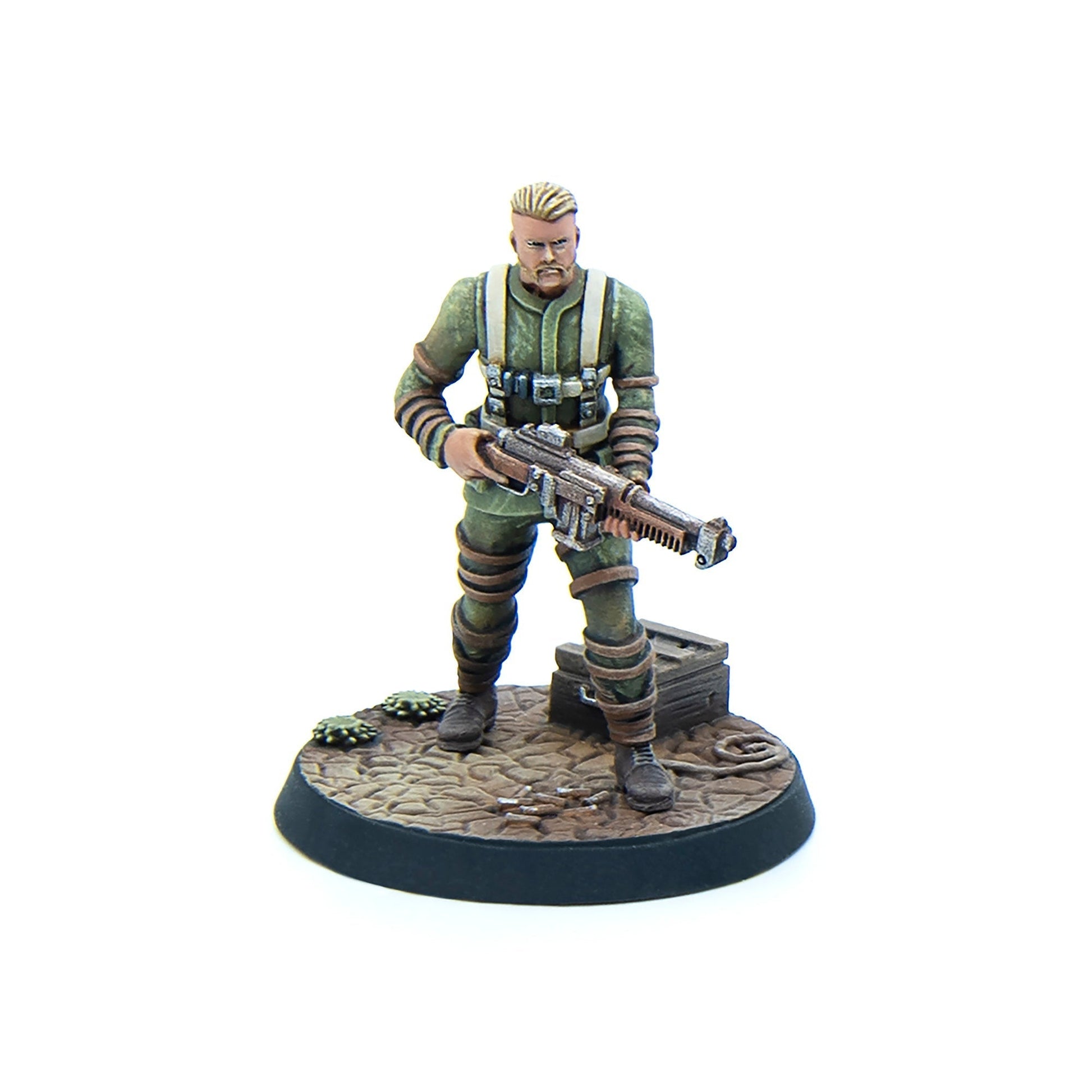 A wargaming miniature: a soldier in green uniform with blonde hair and beard, holding a sci-fi rifle, on a textured base