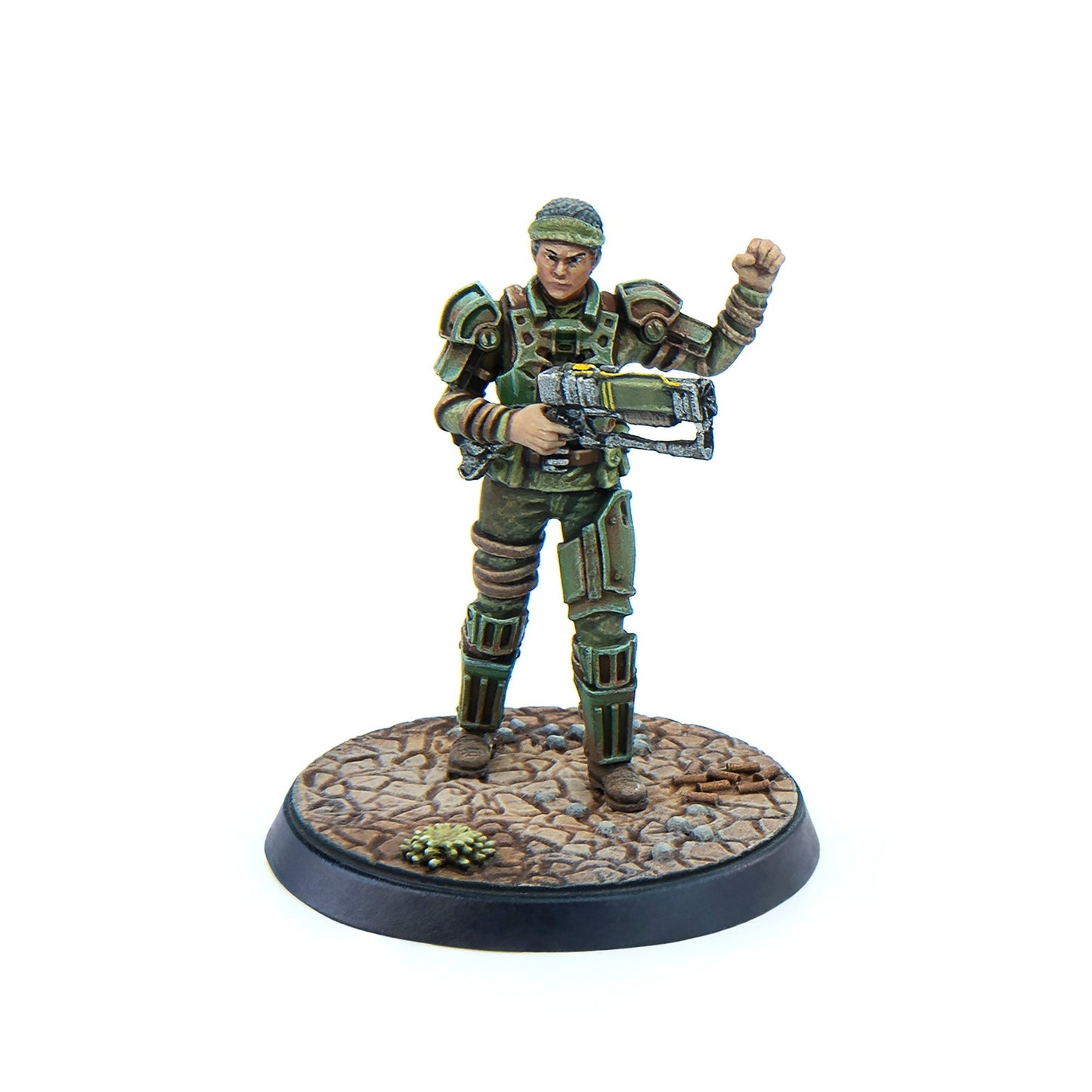 Green armored sci-fi miniature figure holding a rifle, with their left fist raised