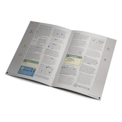 An open Fallout game rulebook shows rules, diagrams, and a 'Helpful Hint from Vault Boy' on two pages