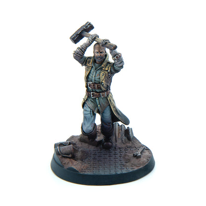 Miniature: Bald, bearded man in a weathered coat raising a large sledgehammer over his head, ready to strike