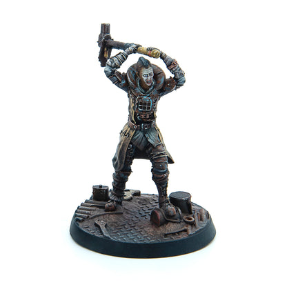 A post-apocalyptic miniature warrior with a mohawk, holding a large hammer raised overhead