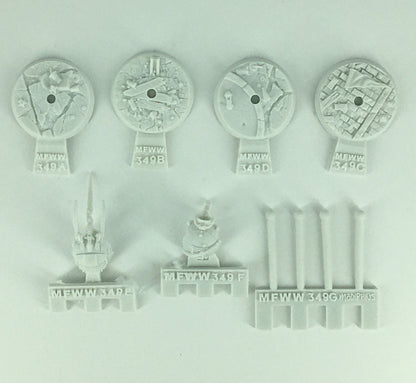 Unpainted light grey model kit parts: four textured bases, two detailed mechanical pieces, and four cylindrical rods
