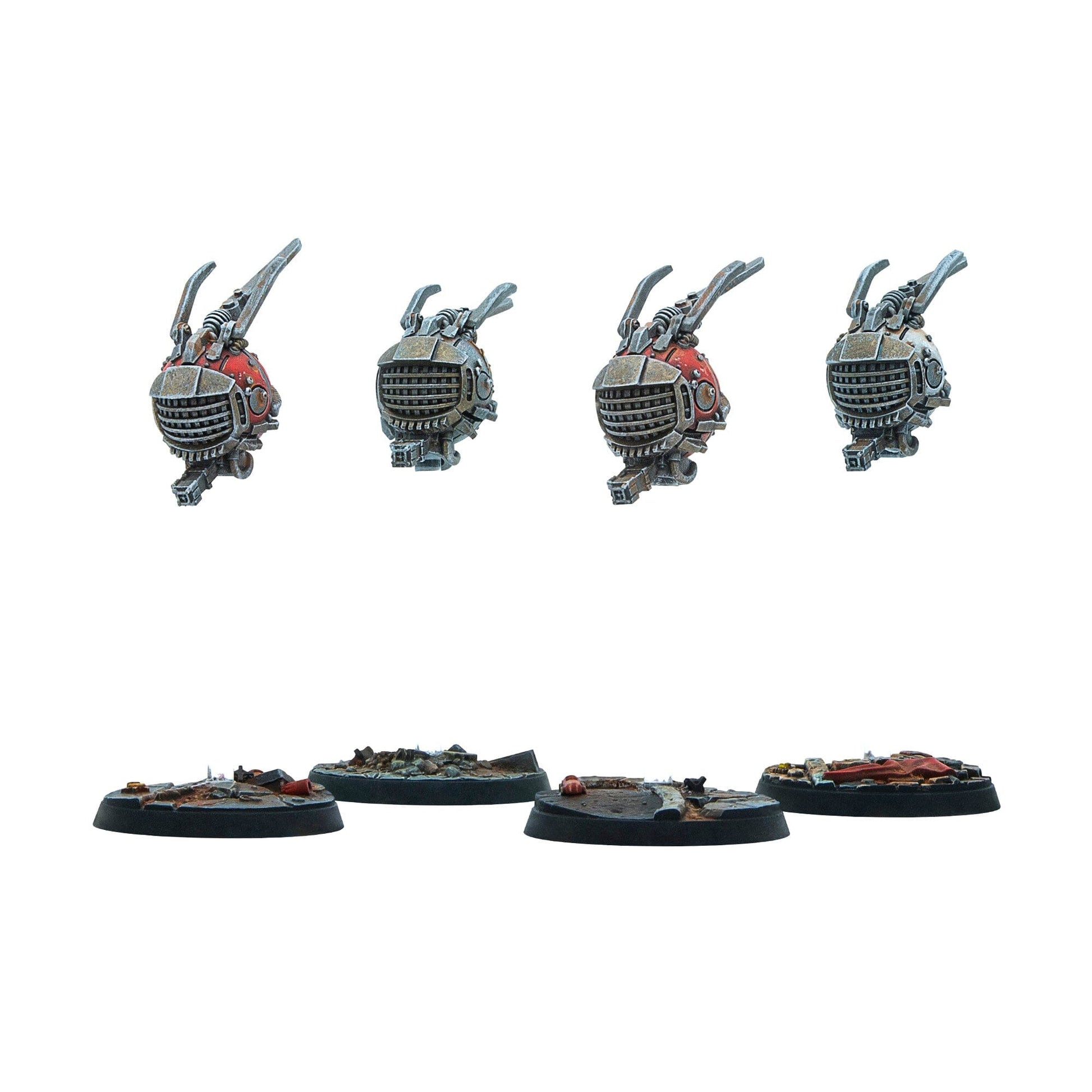Four miniature robot components (two red, two grey) with claw arms, displayed above four rubble-covered bases