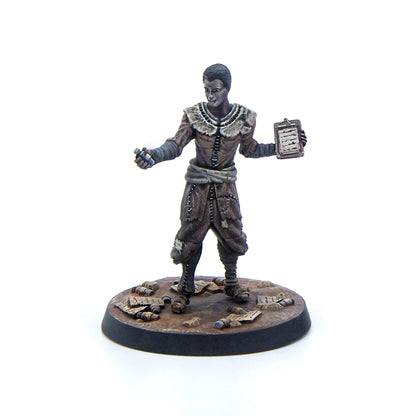 Miniature of a man in tattered clothes holding a clipboard and gesturing, on a debris base