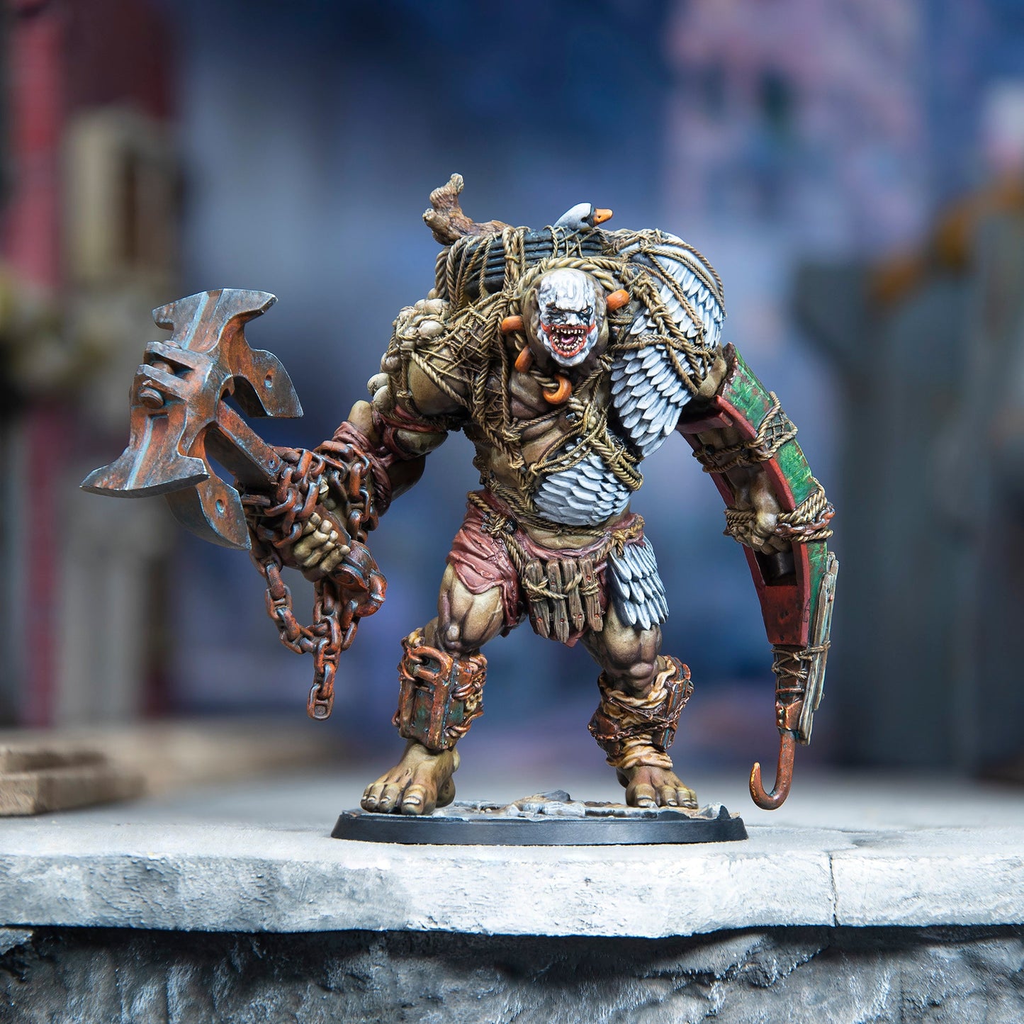 Highly detailed miniature of a hulking, pale-faced monster gripping a rusted axe and hook arm