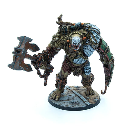 A hulking, weathered monster miniature with a gaping, toothy maw, wielding a large anchor-axe and a hook hand