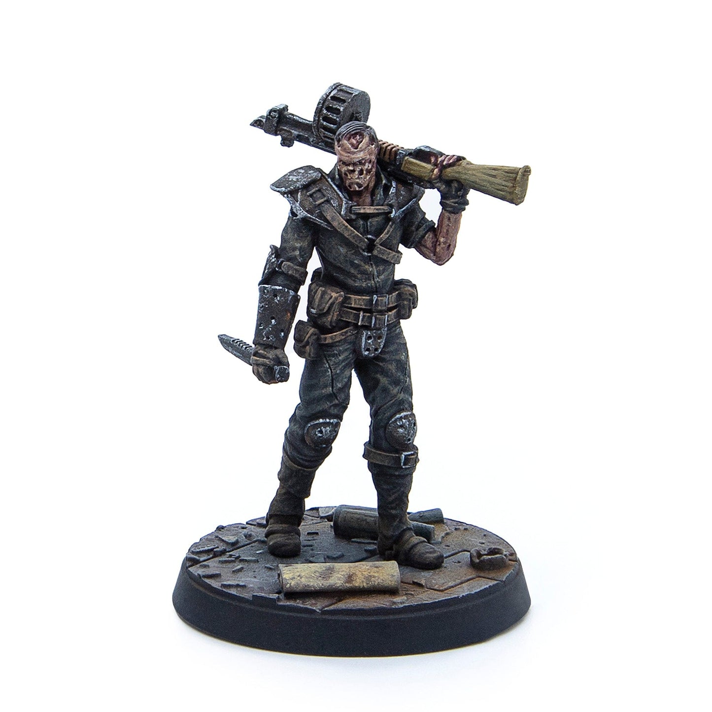 Painted miniature of a ghoulish figure with exposed skull, shouldering a rocket launcher and holding a knife