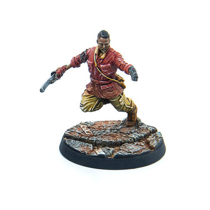 Close-up view of the unpainted Jake Finch miniature from Fallout: Wasteland Warfare, showing sculpted weapon and outfit details