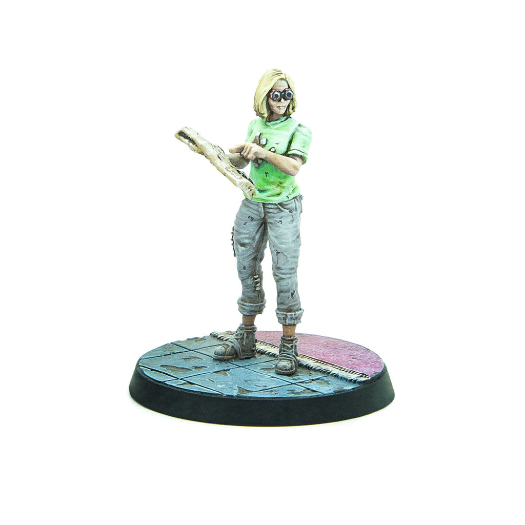 Blonde female miniature in green shirt and goggles, inspecting a crude wooden tool