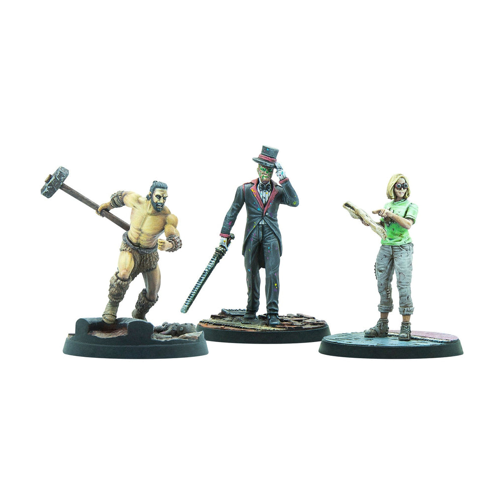 Three painted miniature figures: a barbarian with a hammer, a zombie in a tuxedo with a sword, and a woman reading a book