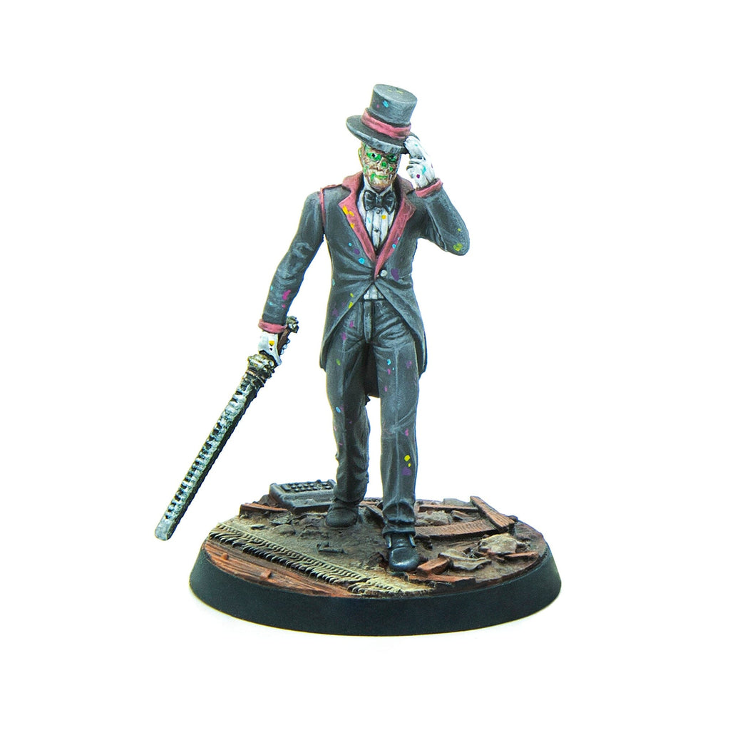 A miniature of a green-faced figure in a paint-splattered suit, tipping a top hat and holding a serrated sword