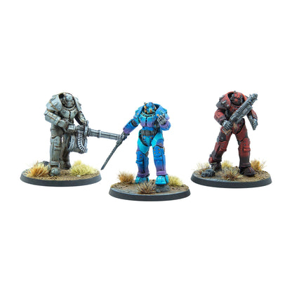 Three Fallout power armor miniatures: grey with heavy machine gun, blue/purple with staff, and red with shotgun