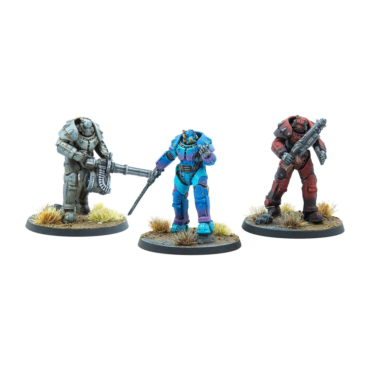 Three Fallout power armor miniatures: grey with heavy machine gun, blue/purple with staff, and red with shotgun