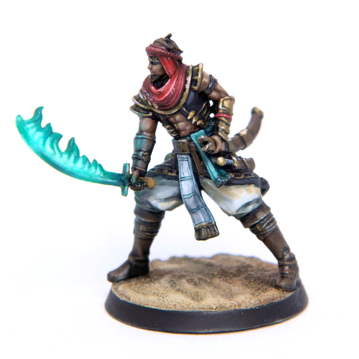 A painted fantasy miniature of a desert warrior in a red turban, holding a vibrant turquoise wavy scimitar, on a sandy base.
