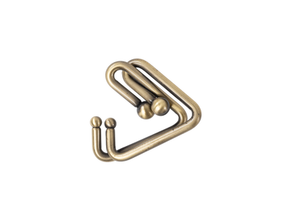 Stylized antique brass double hook accessory with ball tips, isolated on black