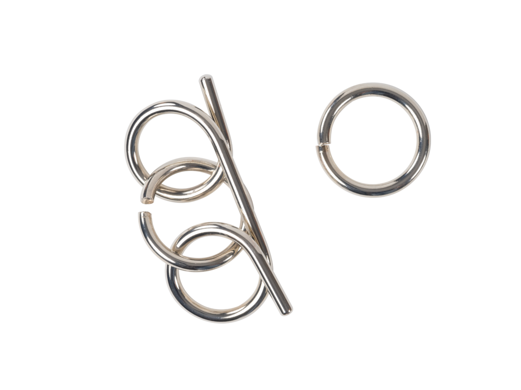 Silver wire disentanglement puzzle (rod and loops) and a separate ring on a black background
