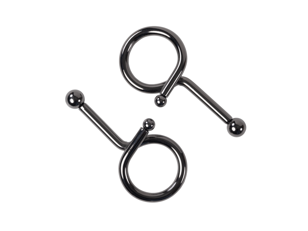 Two shiny dark metal pieces, each having a loop and a straight bar ending in a ball, against a black background