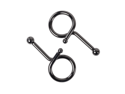 Two shiny dark metal pieces, each having a loop and a straight bar ending in a ball, against a black background