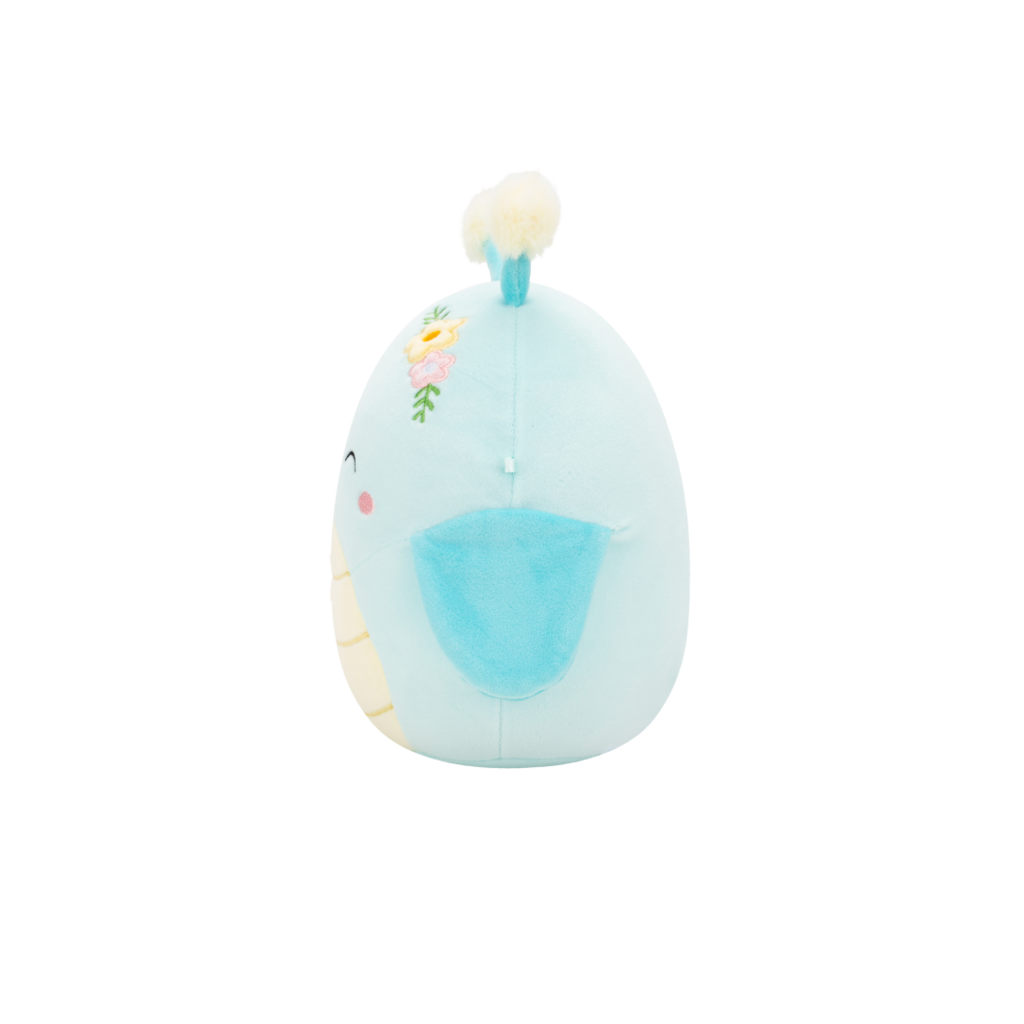 Round, light blue plush toy with embroidered flowers and a cream tuft on top, viewed in profile