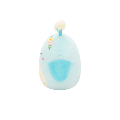 Round, light blue plush toy with embroidered flowers and a cream tuft on top, viewed in profile