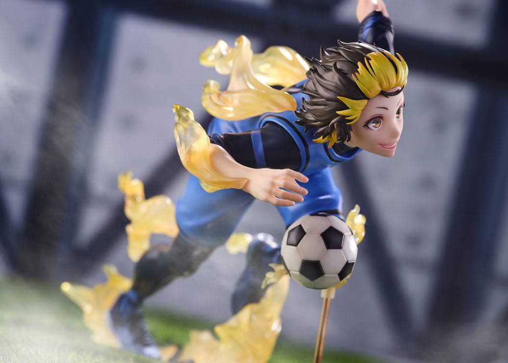 Anime figure of a soccer player in a blue uniform and yellow hair kicking a ball