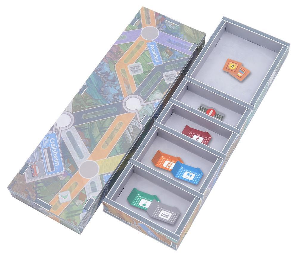 Detailed view of insert compartments holding assorted game pieces