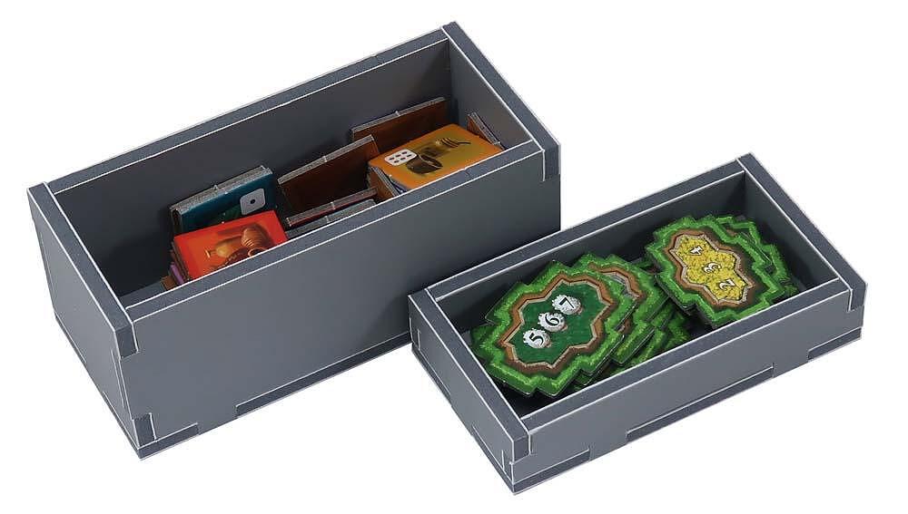 Close-up of the Folded Space insert showing divided slots for game pieces and dice